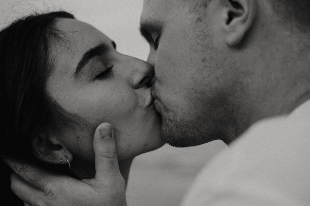 romantically kissing on the beach